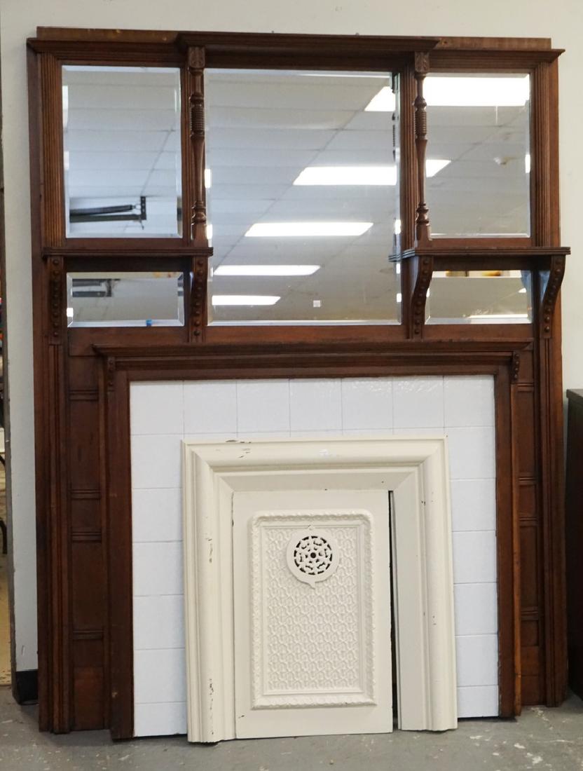 CARVED AND TILED WALNUT MANTEL WITH A CAST IRON INSERT.: CARVED AND TILED WALNUT MANTEL WITH A CAST IRON INSERT. 61 INCHES WIDE. 77 INCHES HIGH.