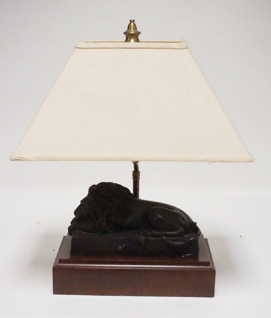 BRONZE SLEEPING LION SCULPTURE MOUNTED AS A LAMP. THE: BRONZE SLEEPING LION SCULPTURE MOUNTED AS A LAMP. THE FIGURE IS NOT ALTERED. IT IS MOUNTED ON A WOODEN BASE THAT HA SA LIGHT FIXTURE ATTACHED. LATM MEASURES 19 INCHES HIGH.