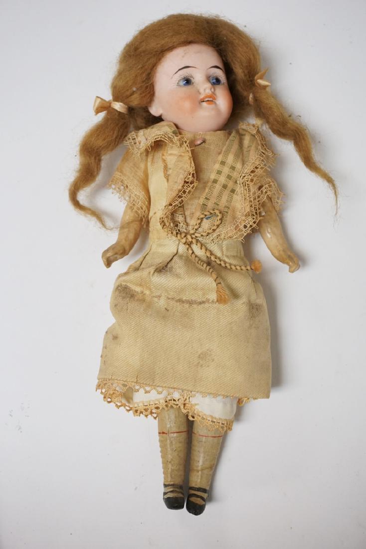 GERMAN BISQUE HEAD DOLL MEASURING 10 1/4 INCHES LONG. (1 of 1)