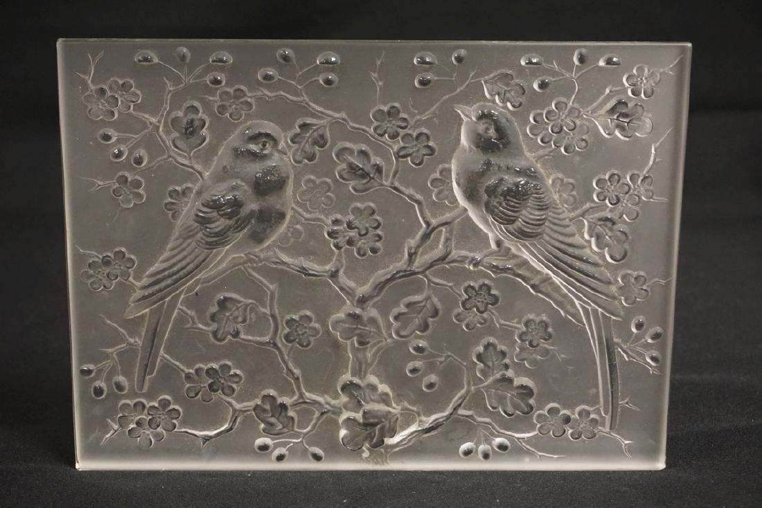 ART GLASS: FROSTED CRYSTAL PANEL WITH RELIEF DECORATION OF BIRDS IN A FLOWERING TREE. SIGNED. 10 1/8 X 7 3/8 AND 7/8 INCHES THICK. HAS A COUPLE OF SLIGHTLY ROUGH CORNERS.