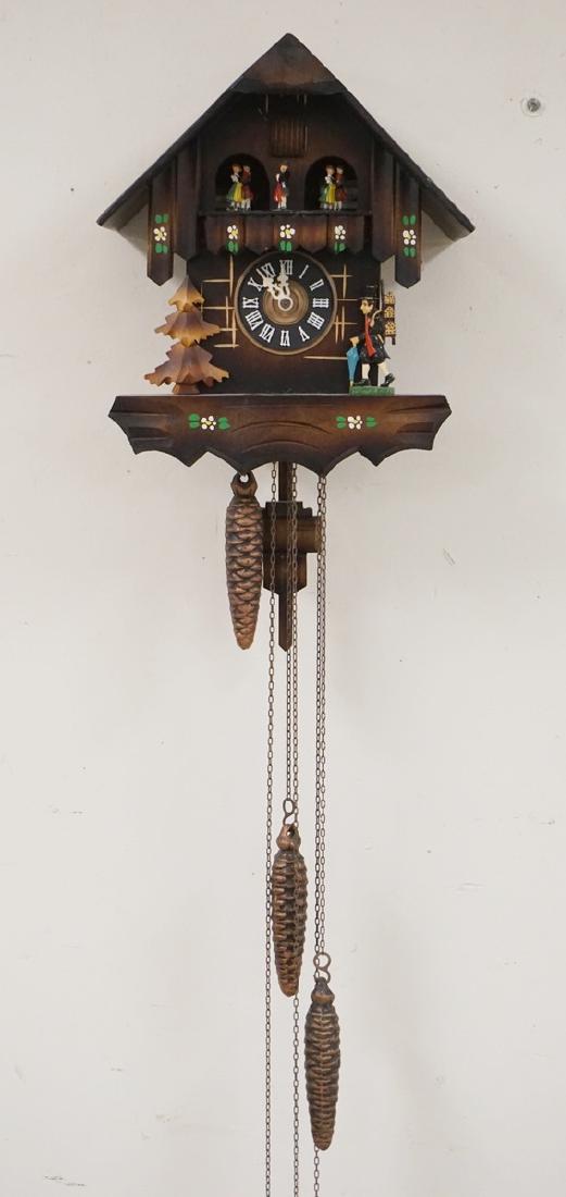 GERMAN CUCKOO CLOCK: GERMAN CUCKOO CLOCK. CARVED AND PAINT DECORATED. HAS ORIGINAL BOX, WEIGHTS, AND PENDULUM. 11 1/2 X 10 INCHES.