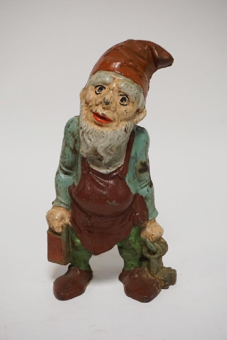 GNOME DOORSTOP: ANTIQUE FIGURAL CAST IRON GNOME WITH KEYS DOORSTOP. 9 3/4 INCHES HIGH.