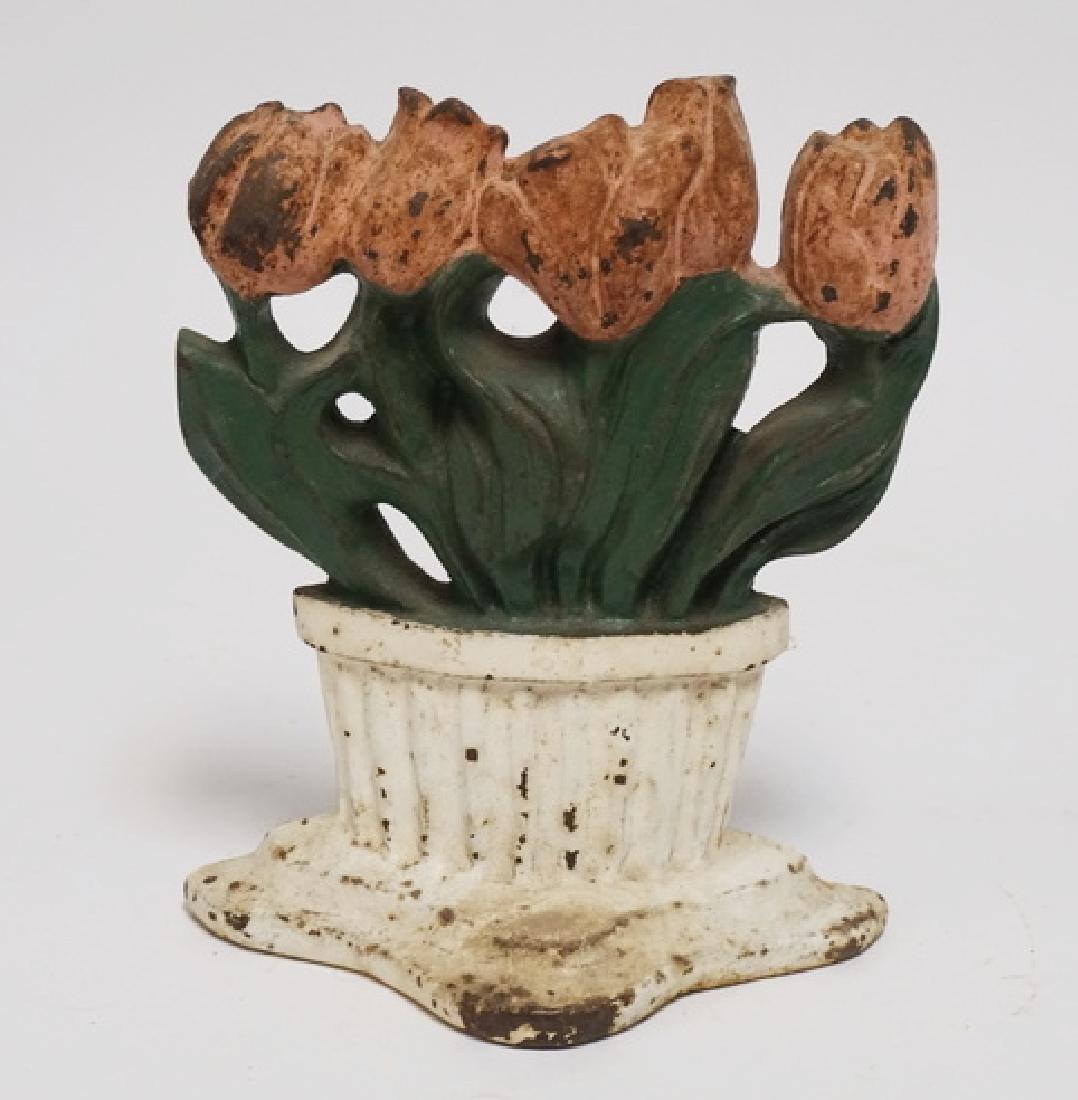 IRON DOORSTOP: ANTIQUE CAST IRON DOORSTOP. TULIPS. 8 1/2 INCHES HIGH.