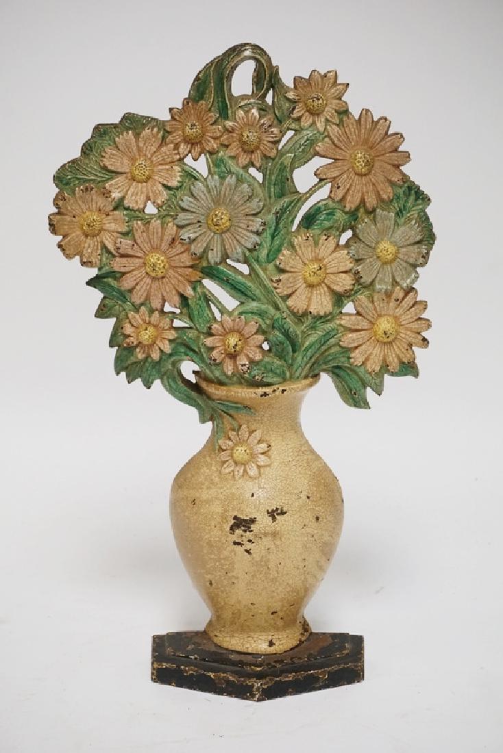 HUBLEY DOORSTOP: ANTIQUE HUBLEY #455 CAST IRON COSMOS DOORSTOP. 17 3/4 INCHES HIGH.