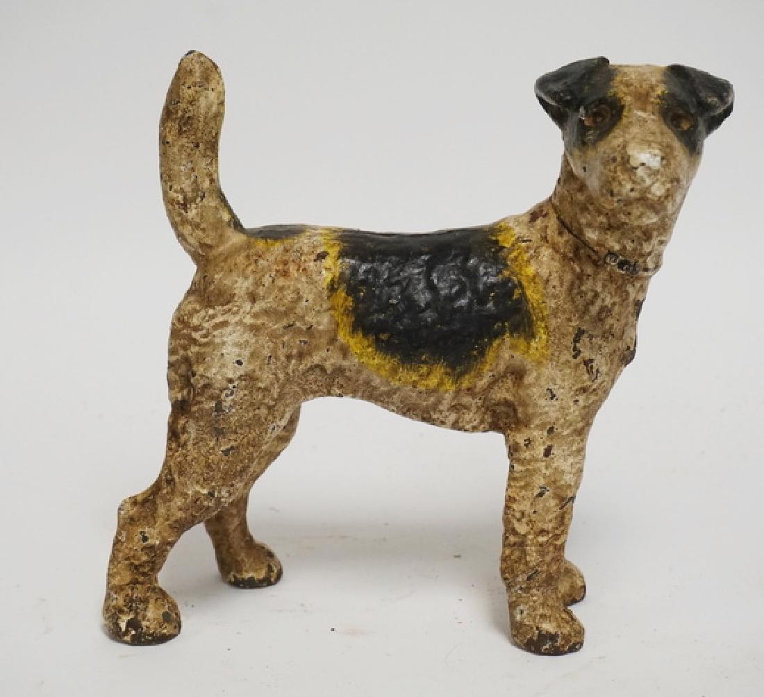 TERIER DOORSTOP/BANK: ANTIQUE CAST IRON TERRIER DOG COIN BANK. 8 1/4 INCHES HIGH.