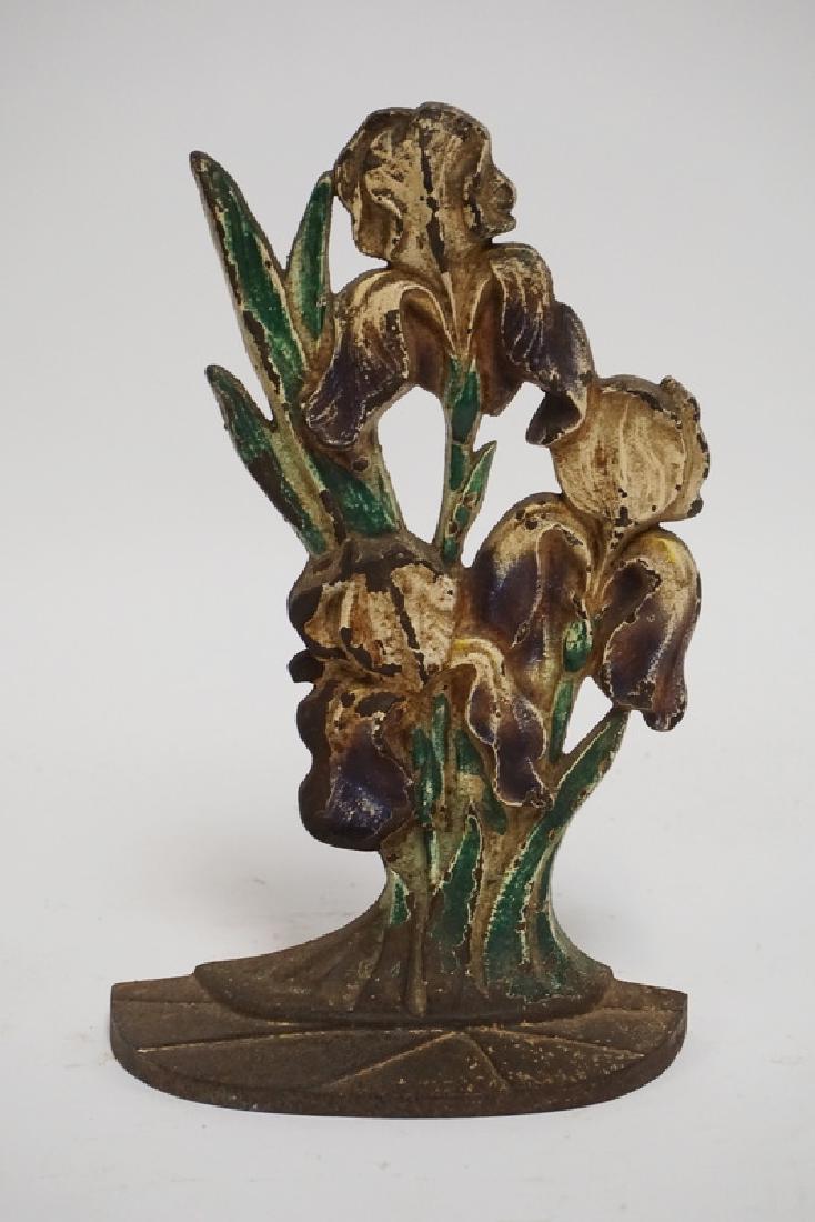 IRON DOORSTOP: ANTIQUE IRON IRIS DOORSTOP. 10 3/4 INCHES HIGH.
