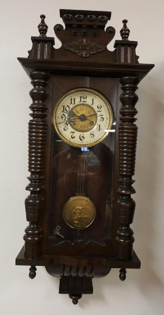 GERMAN REGULATOR CLOCK: GERMAN REGULATOR WALL CLOCK. HALF TURNED COLUMNS. NOUVEAU STYLED PENDULUM. 35 1/2 X 15 INCHES.
