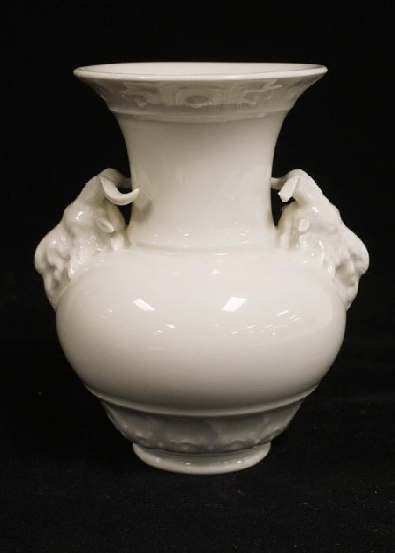 KPM PORCELAIN: KPM PORCELAIN VASE WITH FIGURAL ACCENTS ON THE SHOULDERS. ONE HORN CHIPPED. 6 3/4 INCHES HIGH.
