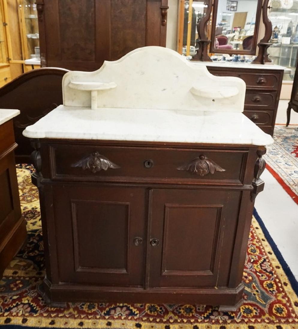 VICTORIAN MARBLE TOP WASHSTAND: VICTORIAN MARBLE TOP WASHSTAND WITH CARVED PULLS AND PANELED DOORS. 34 INCHES WIDE. 41 INCHES HIGH.