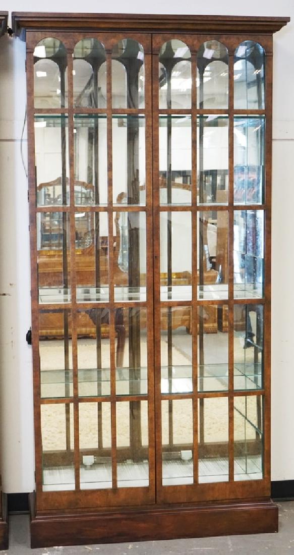 BAKER CURIO CABINET: BAKER CURIO CABINET WITH A MIRRORED BACK, GLASS SHELVES, AND BUBBLE GLASS DOORS. HAS MIRRORS ADDED TO THE SIDES OF THE INTERIOR AND LIGHTING ADDED TO THE BOTTOM. 91 INCHES HIGH. 47 INCHES WIDE.