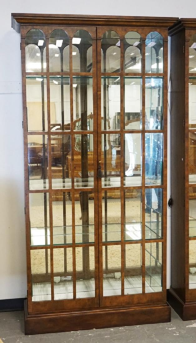BAKER CURIO CABINET: BAKER CURIO CABINET WITH A MIRRORED BACK, GLASS SHELVES, AND BUBBLE GLASS DOORS. HAS MIRRORS ADDED TO THE SIDES OF THE INTERIOR AND LIGHTING ADDED TO THE BOTTOM. 91 INCHES HIGH. 47 INCHES WIDE.