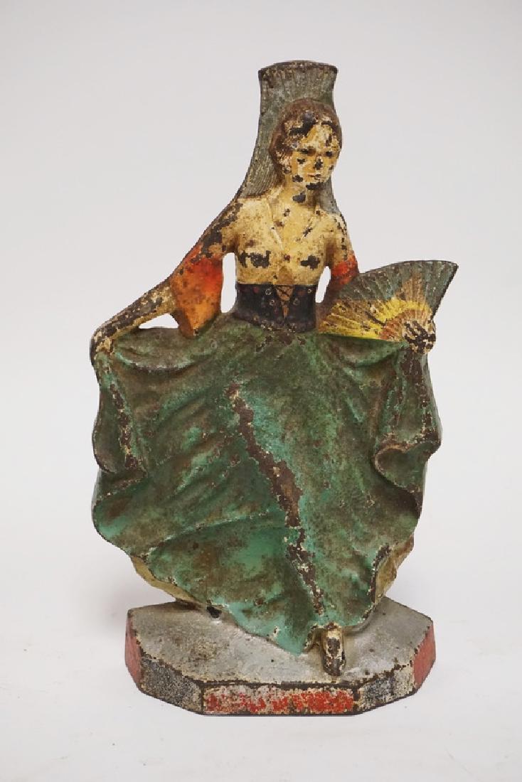ANTIQUE DOORSTOP: ANTIQUE CAST IRON DOORSTOP OF A DANCER HOLDING A FOLDING FAN. 10 INCHES HIGH.