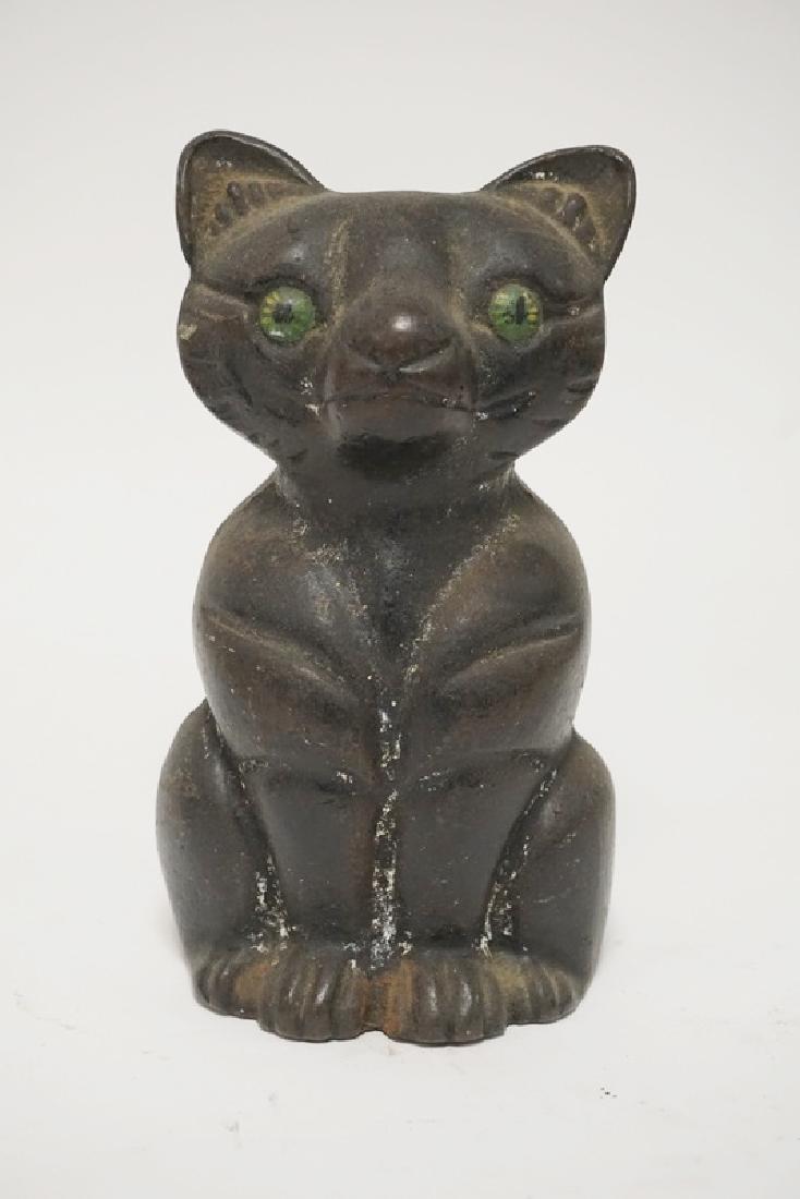 IRON CAT DOORSTOP: CAST IRON CAT DOORSTOP. 6 3/4 INCHES HIGH.