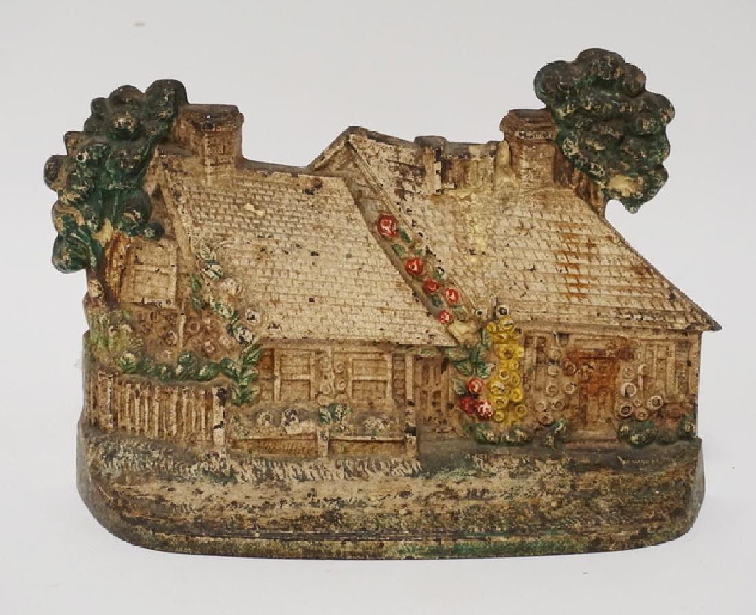 CAST IRON COTTAGE DOORSTOP.