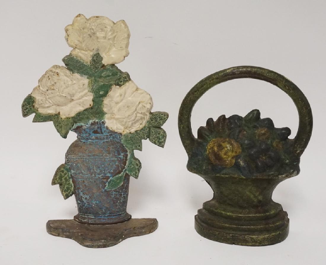 IRON DOORSTOPS: LOT OF 2 CAST IRON FLORAL DOORSTOPS. TALLEST IS 10 3/4 INCHES.