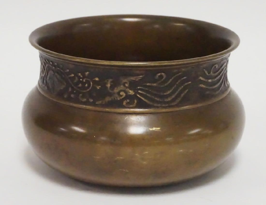 MIDDLE EASTERN BRONZE BOWL WITH A RELIEF DECORATED BAND: MIDDLE EASTERN BRONZE BOWL WITH A RELIEF DECORATED BAND AROUND THE RIM DEPICTING BIRDS. IMPRESSED MARK IN THE BOTTOM. 5 3/4 INCH DIA. 3 1/2 INCHES HIGH.