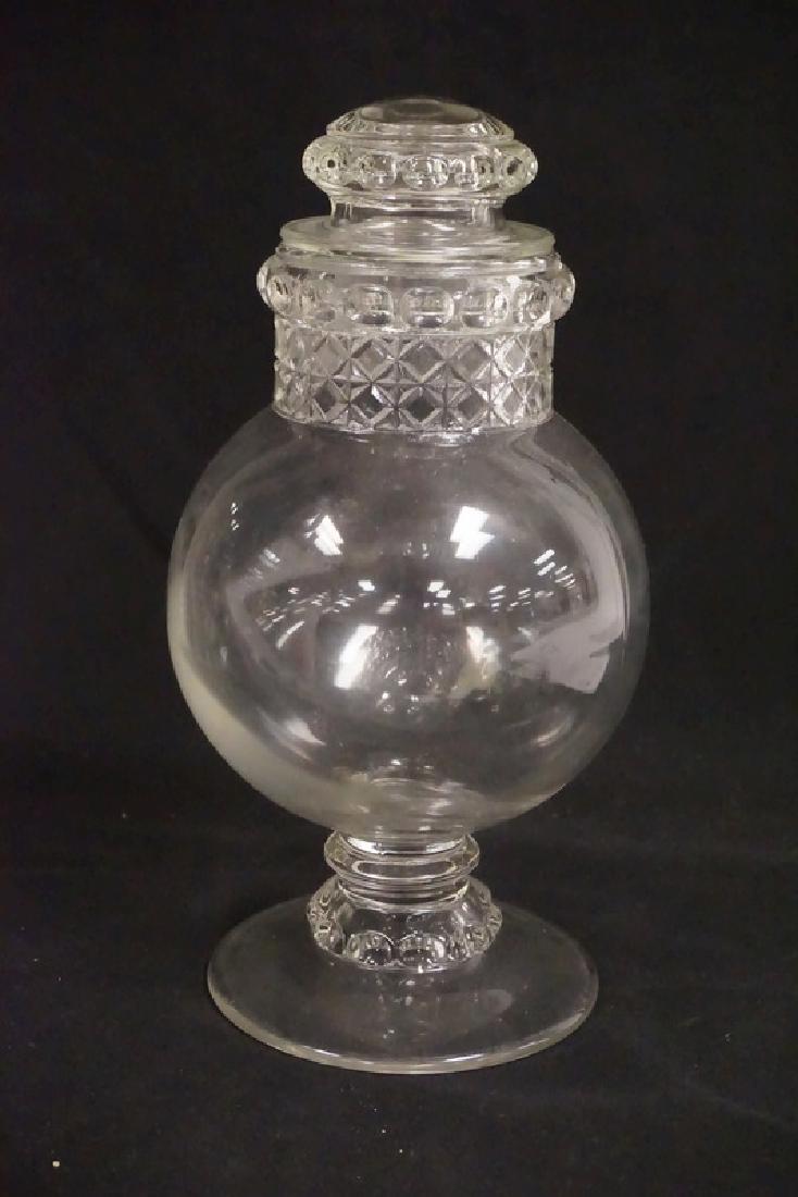 GLASS APOTHECARY JAR: GLASS APOTECARY JAR WITH LID. FOOTED BASE. 11 1/2 INCHES HIGH.