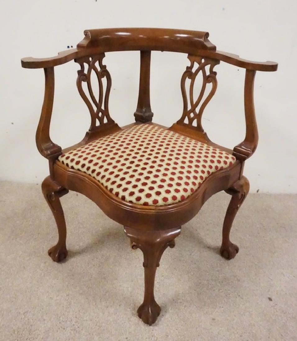 CARVED CORNER CHAIR: CARVED MAHOGANY CORNER CHAIR WITH BALL AND CLAW FEET AND OPENWORK SPLATS. 32 INCHES HIGH. 29 INCHES WIDE.