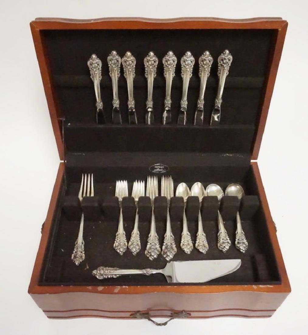 WALLACE GRANDE BAROQUE FLATWARE SET: 42 PIECE WALLACE *GRANDE BAROQUE* STERLING SILVER FLATWARE SET. SERVICE FOR 8 PLUS A SERVING FORK AND A CAKE SERVER. 56.55 TROY OZ INCLUDING .5 TROY OZ PER KNIFE & SERVING HANDLE.
