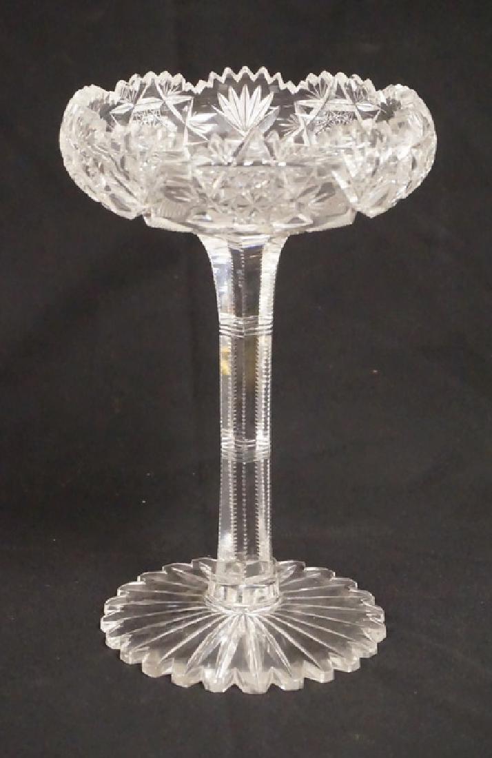 CUT GLASS COMPOTE: CUT GLASS COMPOTE WITH A FOOTED BASE AND A TALL STEM. 9 1/4 INCHES HIGH. 5 7/8 INCH DIA.