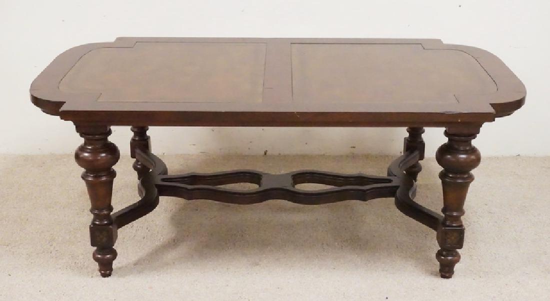 COFFEE TABLE: CARVED LEATHER TOP COFFEE TABLE WITH BALUSTER LEGS. 54 X 32 INCH TOP. 19 3/4 INCHES HIGH.