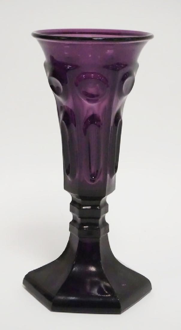 NEW ENGLAND FLINT GLASS VASE: NEW ENGLAND AMETHYST FLINT GLASS VASE WITH A PATTERN OF CIRCLES AND ELIPSES. FLARED STRAIGHT RIM. CIRCA 1850-70 8 5/8 IN HIGH
