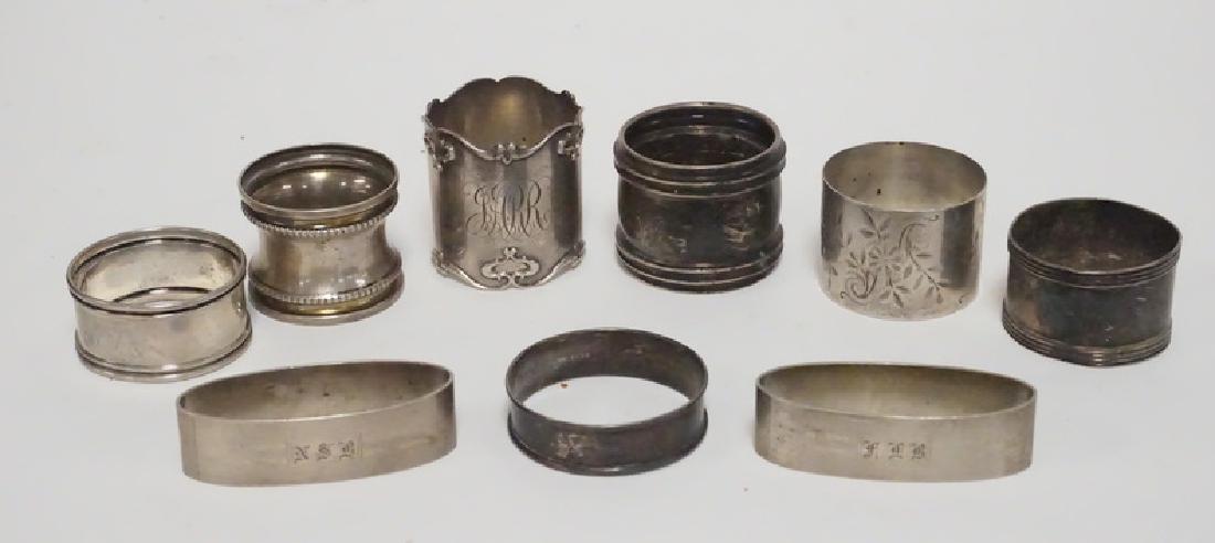 STERLING SILVER NAPKIN RINGS: LOT OF 9 STERLING SILVER NAPKIN RINGS. 5.52 TROY OZ