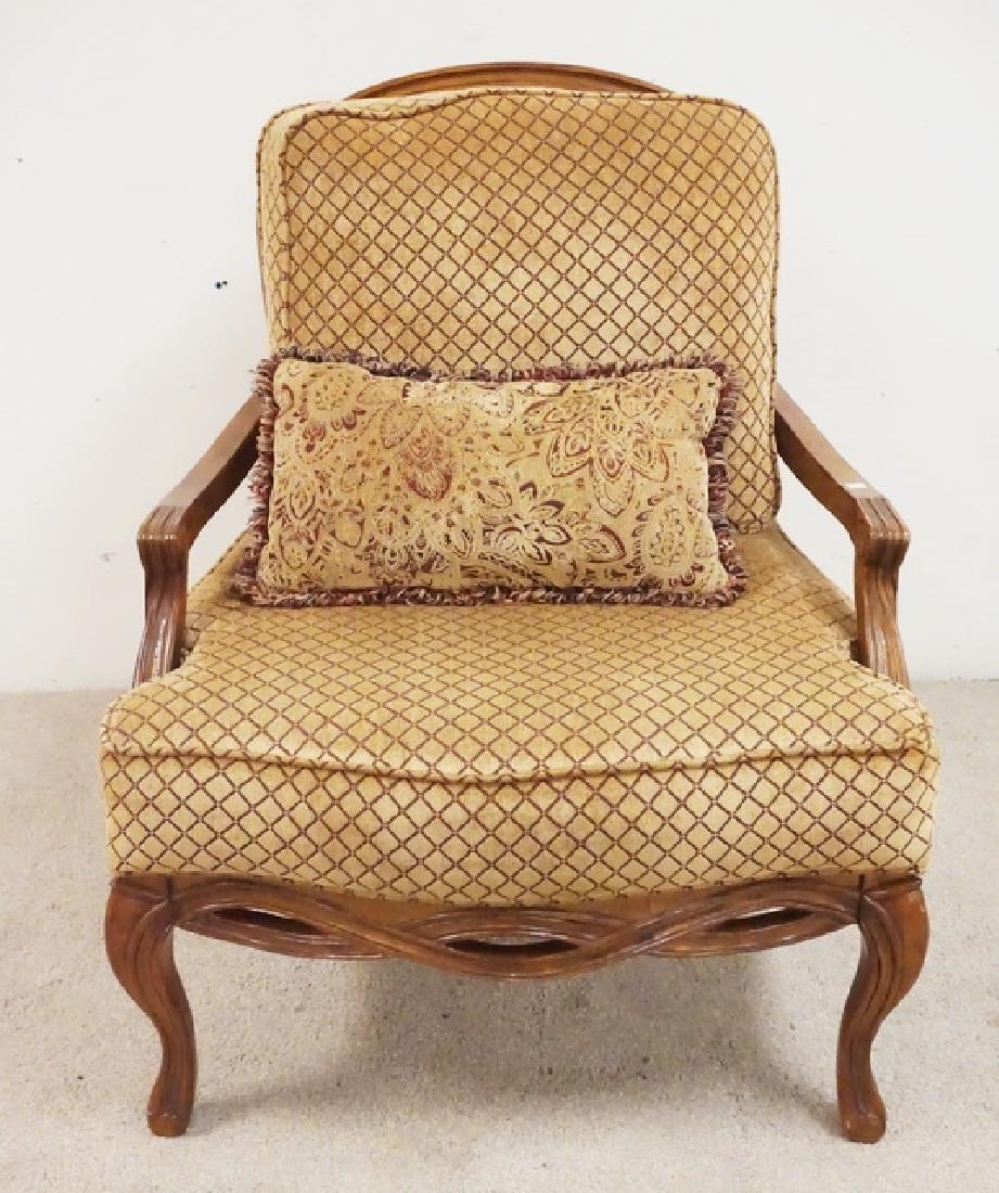 CARVED AND UPHOLSTERED ARMCHAIR: EXTRA WIDE CARVED AND UPHOLSTERED ARMCHAIR. CANED BACK. 33 INCHCES WIDE. 41 INCHES HIGH.
