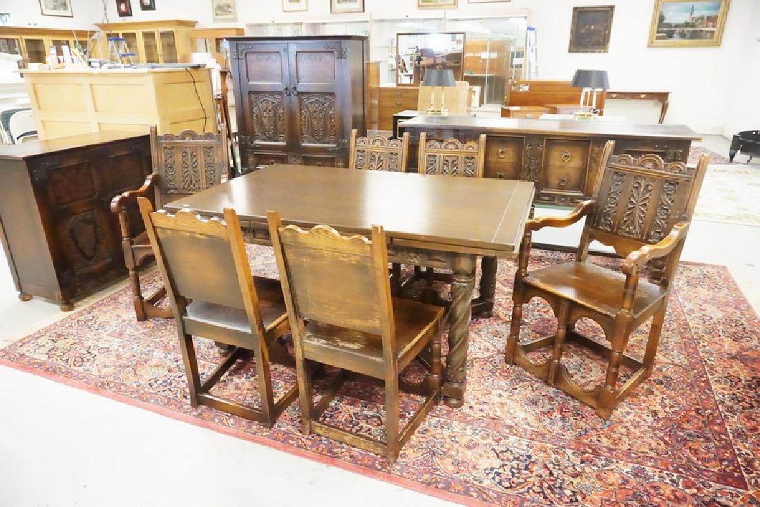 CARVED OAK DINIUNG ROOM SET: GOTHIC CARVED OAK DINING ROOM SET. 9 PIECE INCLUDING TABLE WITH PULL OUT LEAVES, 6 CHAIRS, A SIDEBOARD, AND A CHINA CABINET.