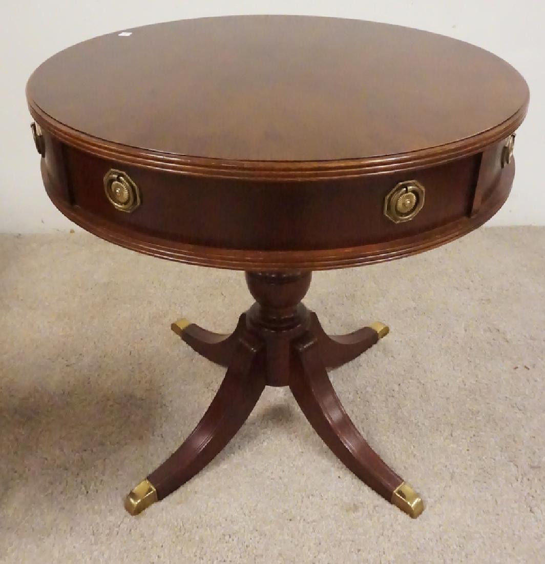 MAHOGANY TABLE: MAHOGNY DRUM TABLE W/BRASS FEET. 26 INCHES HIGH. 26 INCH DIA.