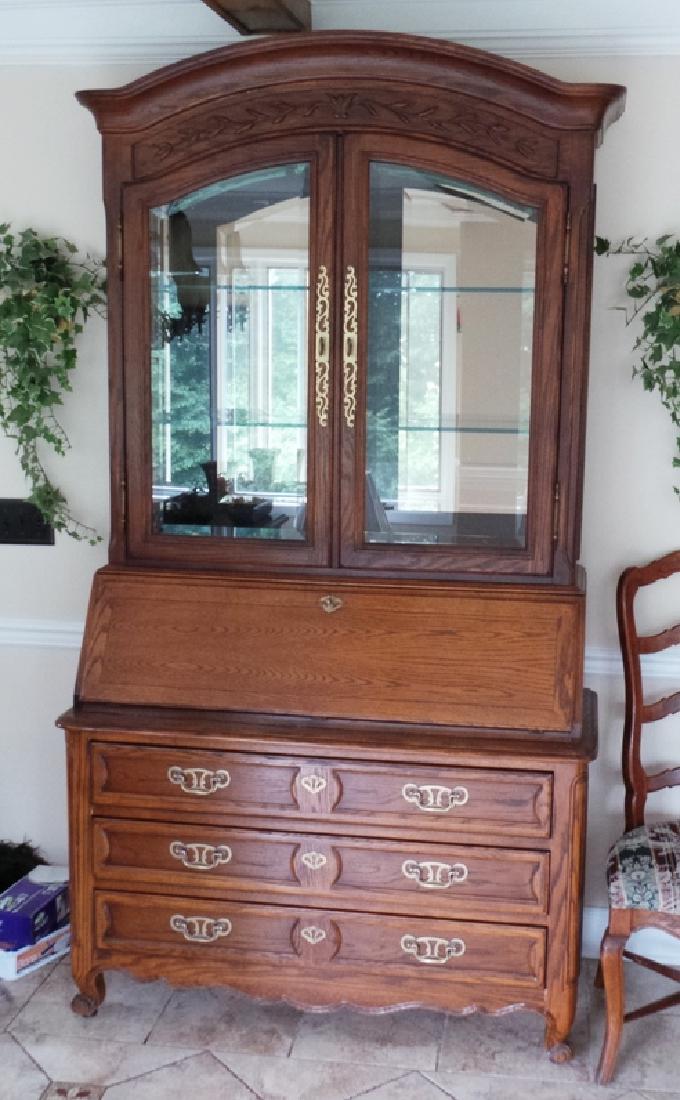 CENTURY OAK SECRETARY: CENTURY OAK SLANT FRONT SECRETARY.TOP HAS LIGHTING, MIRROR BACK AND GLASS SHELVES. 48 IN WIDE, 86 IN H