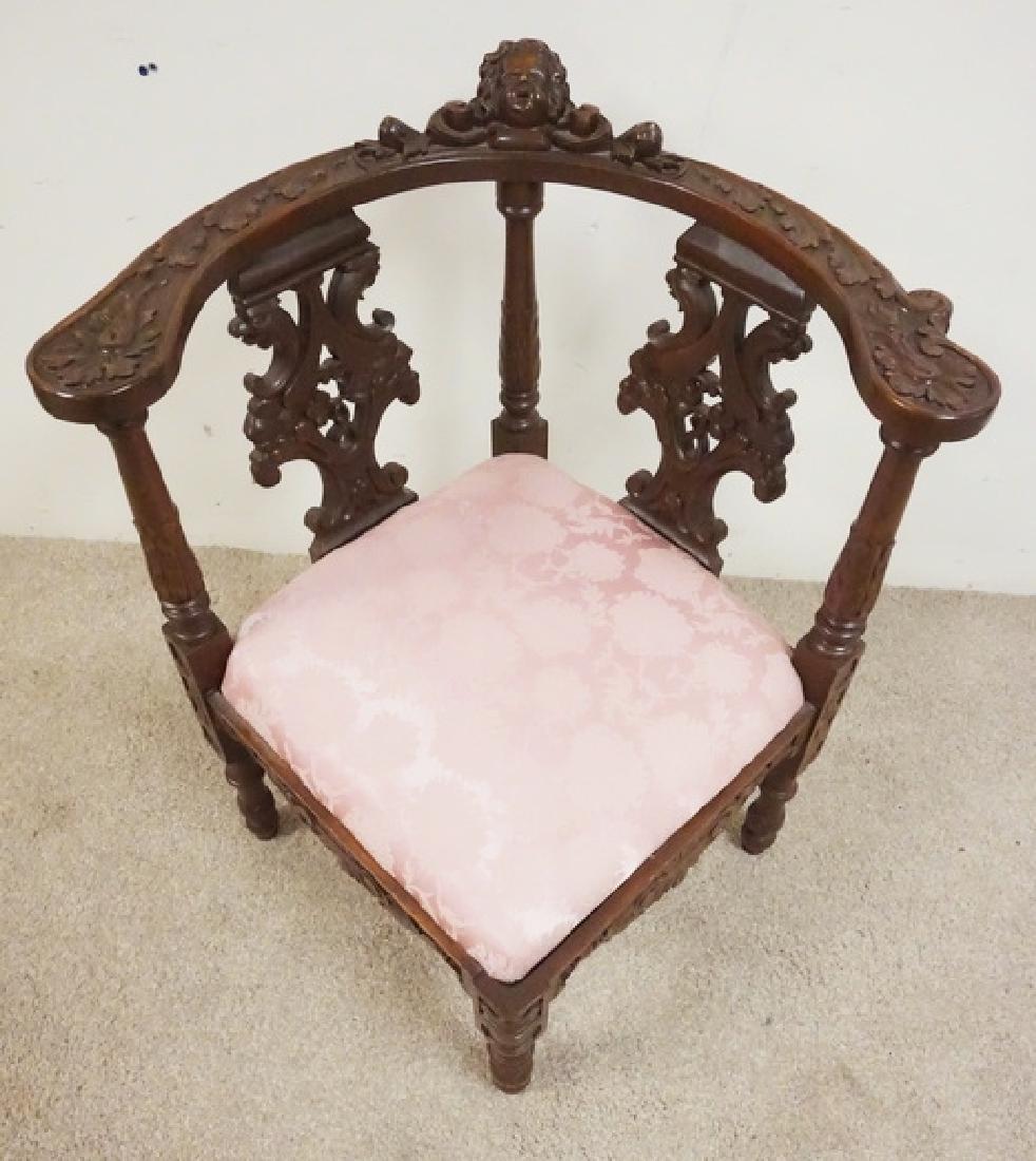 CARVED CORNER CHAIR: ORNATELY CARVED CORNER CHAIR. 26 3/4 INCHES WIDE. 31 INCHES HIGH.