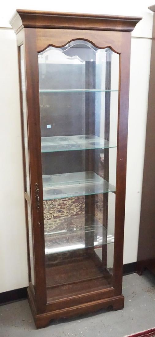 CURIO CABINET: CURIO CABINET WITH GLASS SHELVES, A MIRRORED BACK, AND A LIGHTED INTERIOR.