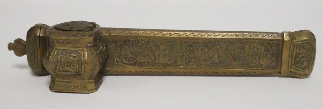 MIDDLE EASTERN TOOLED BRASS PEN AND INK HOLDER: MIDDLE EASTERN HAND TOOLED BRASS PEN AND INK HOLDER. 7 5/8 INCHES LONG.