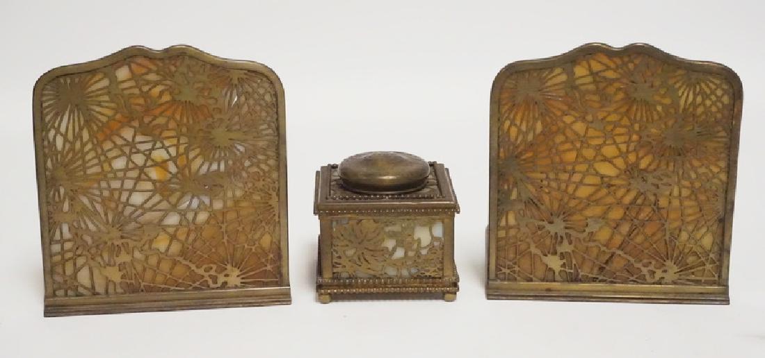 3 PCS TIFFANY STUDIOS BRONZE DESK PIECES: 3 PCS TIFFANY STUDIOS BRONZE. 2 BOOKENDS IN THE PINECONE PATTERN (GLASS BROKEN IN BOTH). AND A GRAPEVINE INKWELL (SOME LOSSES TO THE METALWORK AROUND THE WELL).