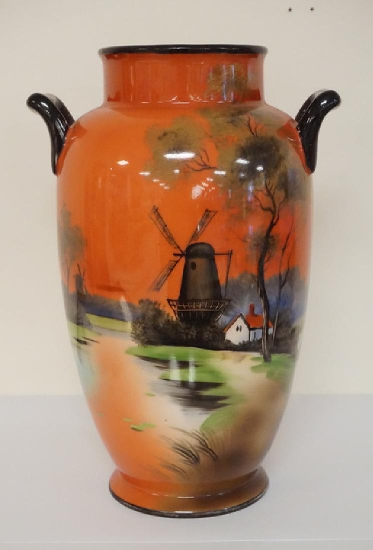 NORITAKE VASE: HAND PAINTED NORITAKE VASE. SCENE INCLUDES WINDMILLS, TREES, AND A COTTAGE BY THE WATER. 10 1/4 INCHES HIGH.