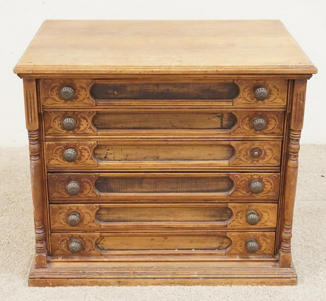 J.P. COATS SPOOL CABINET: J.P. COATS SPOOL CABINET FEATURING FULL TURNED COLUMNS, AND STIPPLED DRAWER FRONTS. 26 1/4 INCHES WIDE. 22 1/4 INCHES HIGH. REMNANTS OF ORIGINAL ADVERTISING PANEL ON THE BACK.