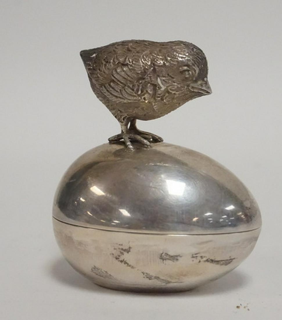 TIFFANY STERLING SILVER: TIFFANY & CO STERLING SILVER BOX IN THE FORM OF A CHICK STANDING ON AN EGG. 2 5/8 INCHES HIGH. 2 1/4 INCHES LONG.