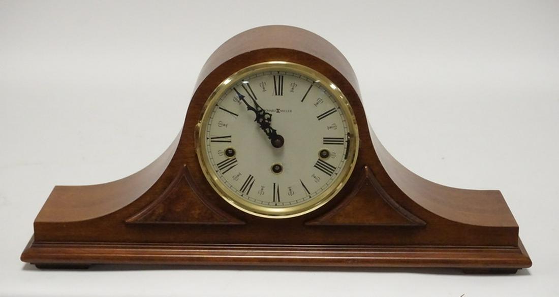HOWARD MILLER HELF CLOCK: HOWARD MILLER CAMELBACK SHELF CLOCK. 20 1/2 INCHES WIDE.