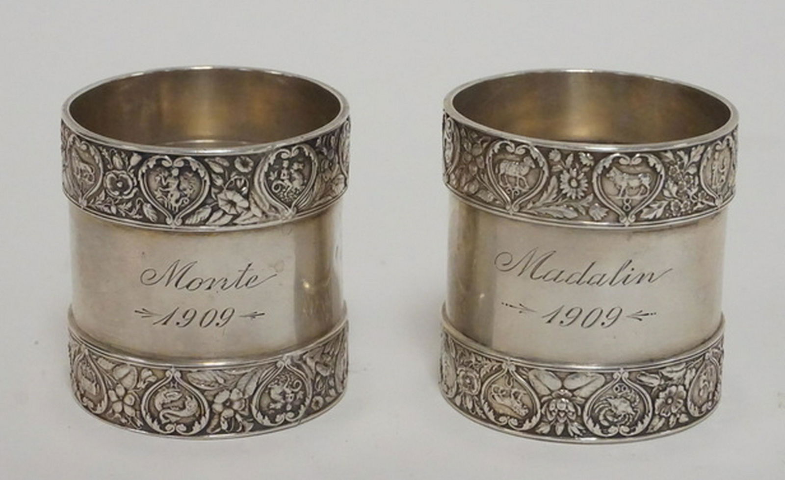 PAIR OF STERLING SILVER NAPKIN RINGS: PAIR OF GORHAM STERLING SILVER NAPKIN RINGS. ENGRAVED WITH NAMES AND 1909. ONE WITH DENTS. 4.57 TROY OZ.
