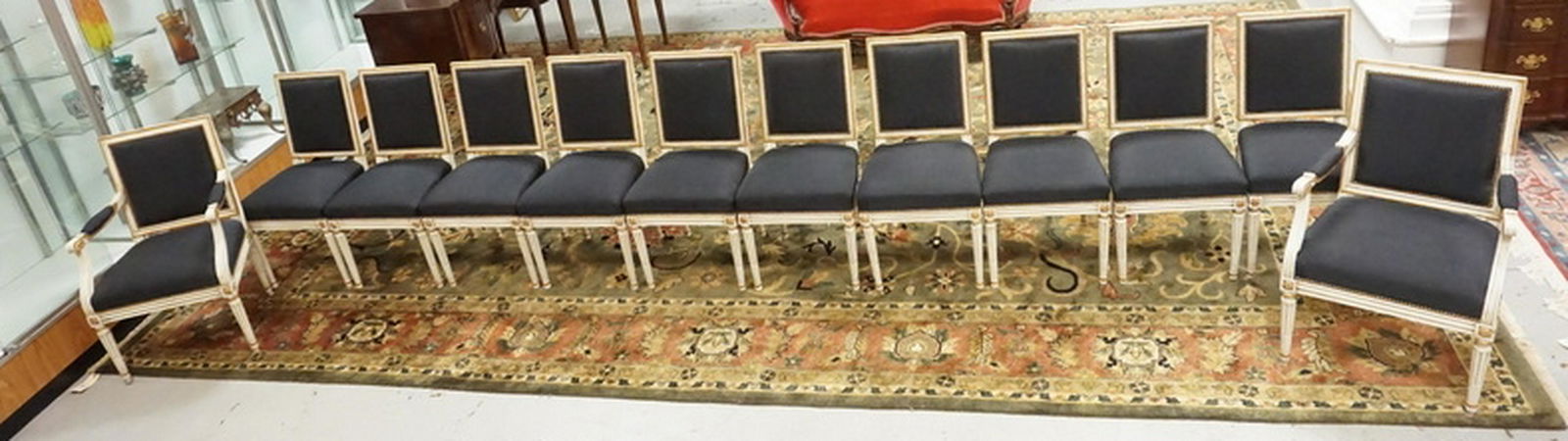 12 DINING CHAIRS: SET OF 12 DINING CHAIRS WITH IN WHITE WITH GOLD ACCENTS ON CARVED DESIGNS.