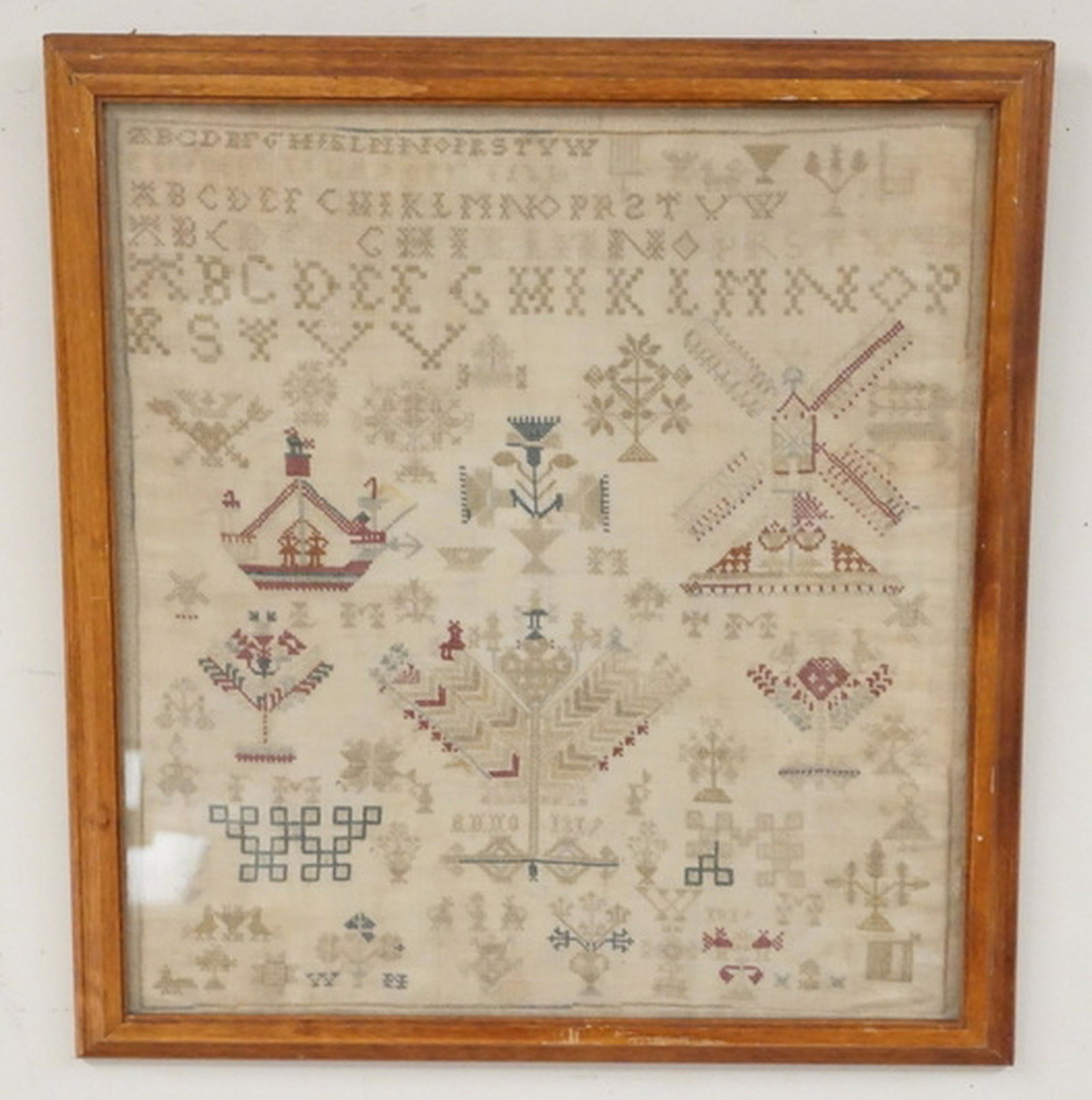 ANTIQUE SAMPLER: ANTIQUE ALPHABET SAMPLER WITH A WINDMILL, TREES, ETC. 13 3/4 X 14 3/4 INCHES.