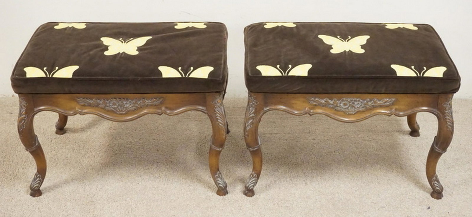PAIR OF CARVED BENCHES WITH BUTTERFLY UPHOLSTERY: PAIR OF CARVED BENCHES WITH BUTTERFLY UPHOLSTERY. 27 X 17 AND 19 INCHES HIGH.