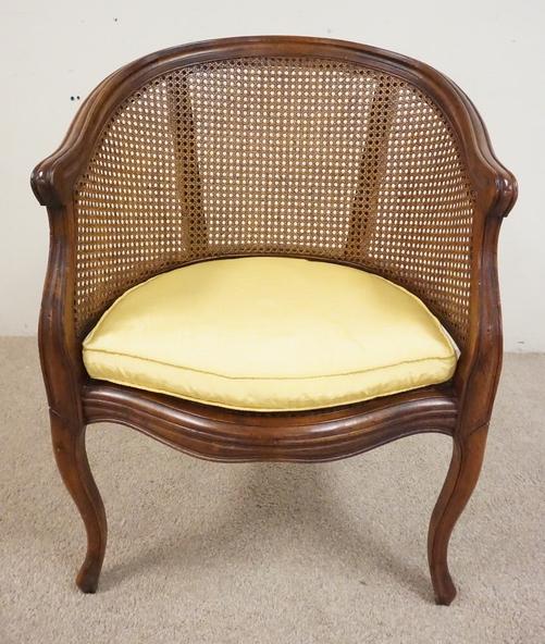 CARVED ARMCHAIR: CARVED ARMCHAIR WITH A CANED SEAT AND BACK. 24 3/4 INCHES WIDE. 34 INCHES HIGH.