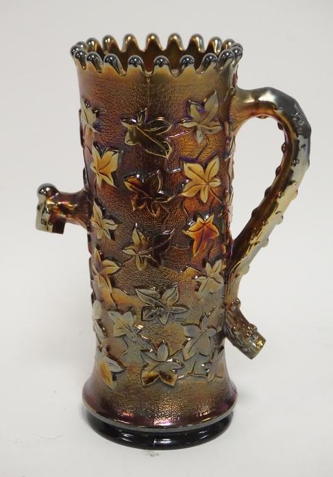 PURPLE CARNIVAL NORTHWOOD TOWN PUMP: SIGNED NORTHWOOD PURPLE CARNIVAL GLASS TOWN PUMP. 6 3/8 IN H. COMES WITH ORIGINAL 1980 AUCTION ADS FROM WHEN IT WAS PURCHASED.