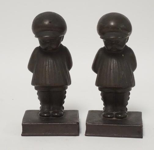 PAIR OF LEAD FIGURES: PAIR OF LEAD FIGURES OF A BOY STANDING ON A BOOK. 6 1/4 INCHES HIGH.