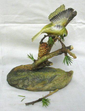 BOEHM BONE PORCELAIN BIRD ON A BOUGH: BOEHM BONE PORCELAIN BIRD ON A BOUGH, ENGLAND; AS IS; BRANCH BROKEN OFF & SOME PINE NEEDLES; 7 1/2 IN H, 7 1/2 IN W; HAVE BRANCH