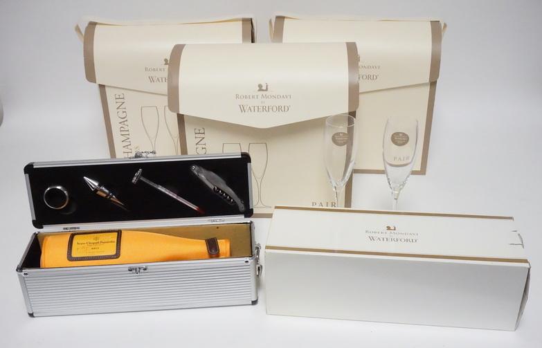 ROBERT MONDAVI WATERFORD: GROUP OF ROBERT MONDAVI WATERFORD ITEMS. 3 PAIR OF CRYSTAL CHAMPAGNE FLUTES AND A BOTTLE COVER & TOOL KIT W/CASE. EACH WITH BOXES.