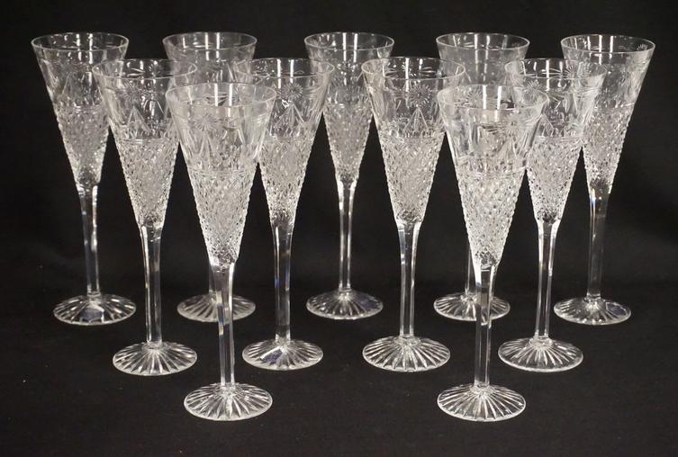 STUART CRYSTAL CHAMPAGNE FLUTES: SET OF 11 STUART CRYSTAL CHAMPAGNE FLUTES. 9 1/8 INCHES HIGH.