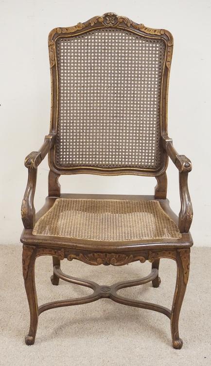CARVED AND CANED ARMCHAIR: CARVED AND CANED ARMCHAIR. 45 1/2 INCHES HIGH. 23 1/2 INCHES WIDE.